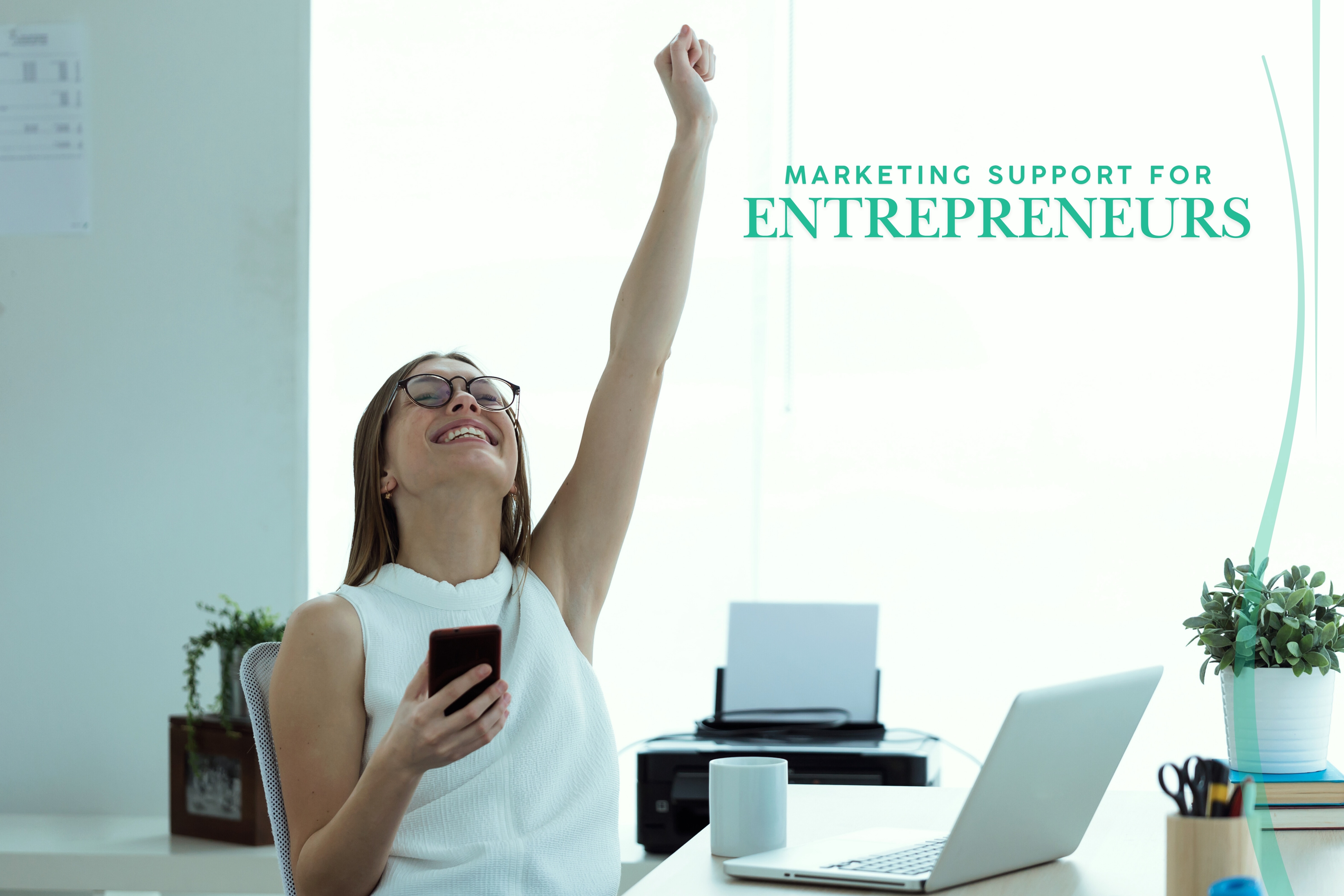 Entrepreneur at desk raising arm in success with laptop and text about marketing support
