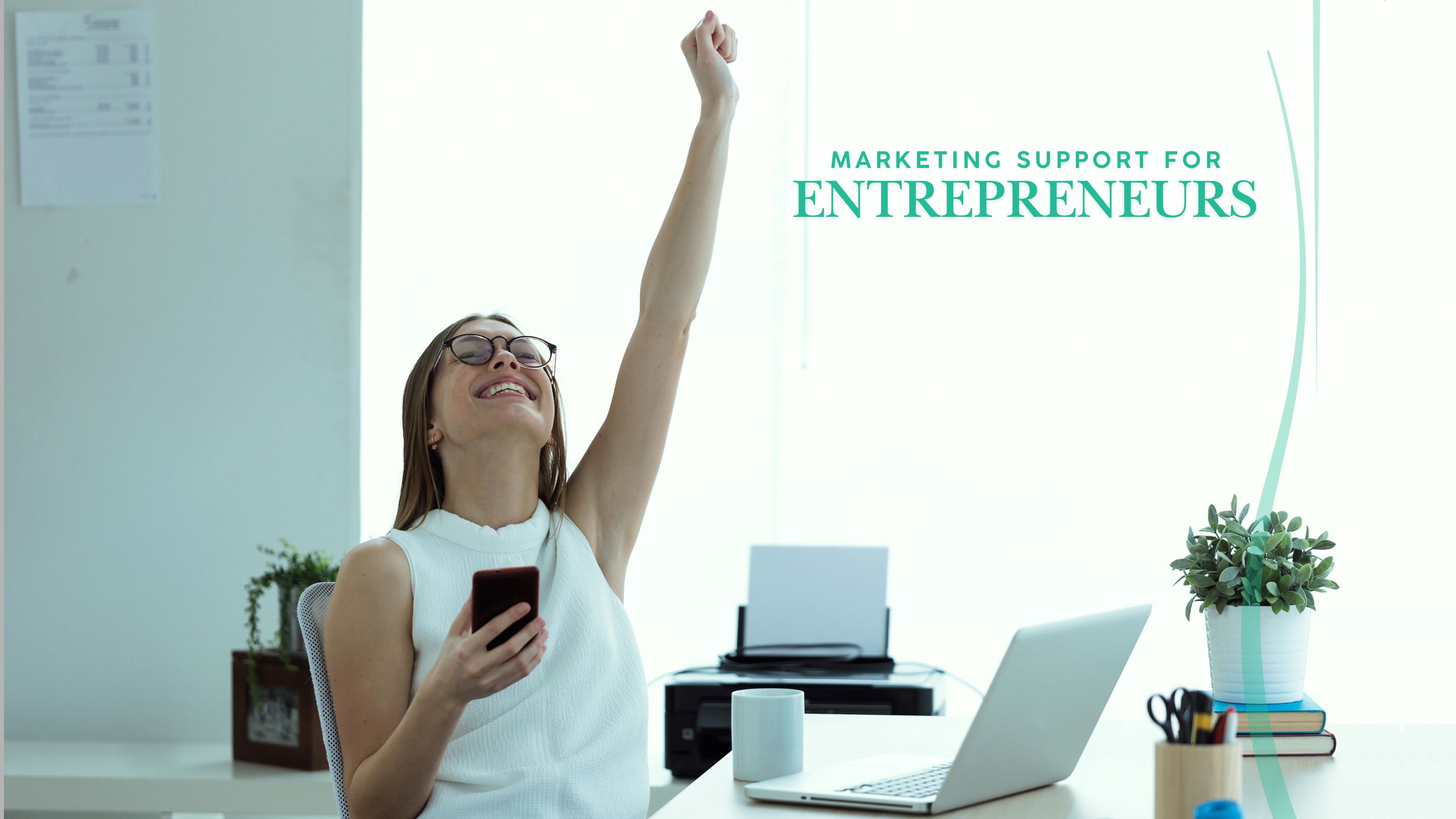 Entrepreneur at desk raising arm in success with laptop and text about marketing support
