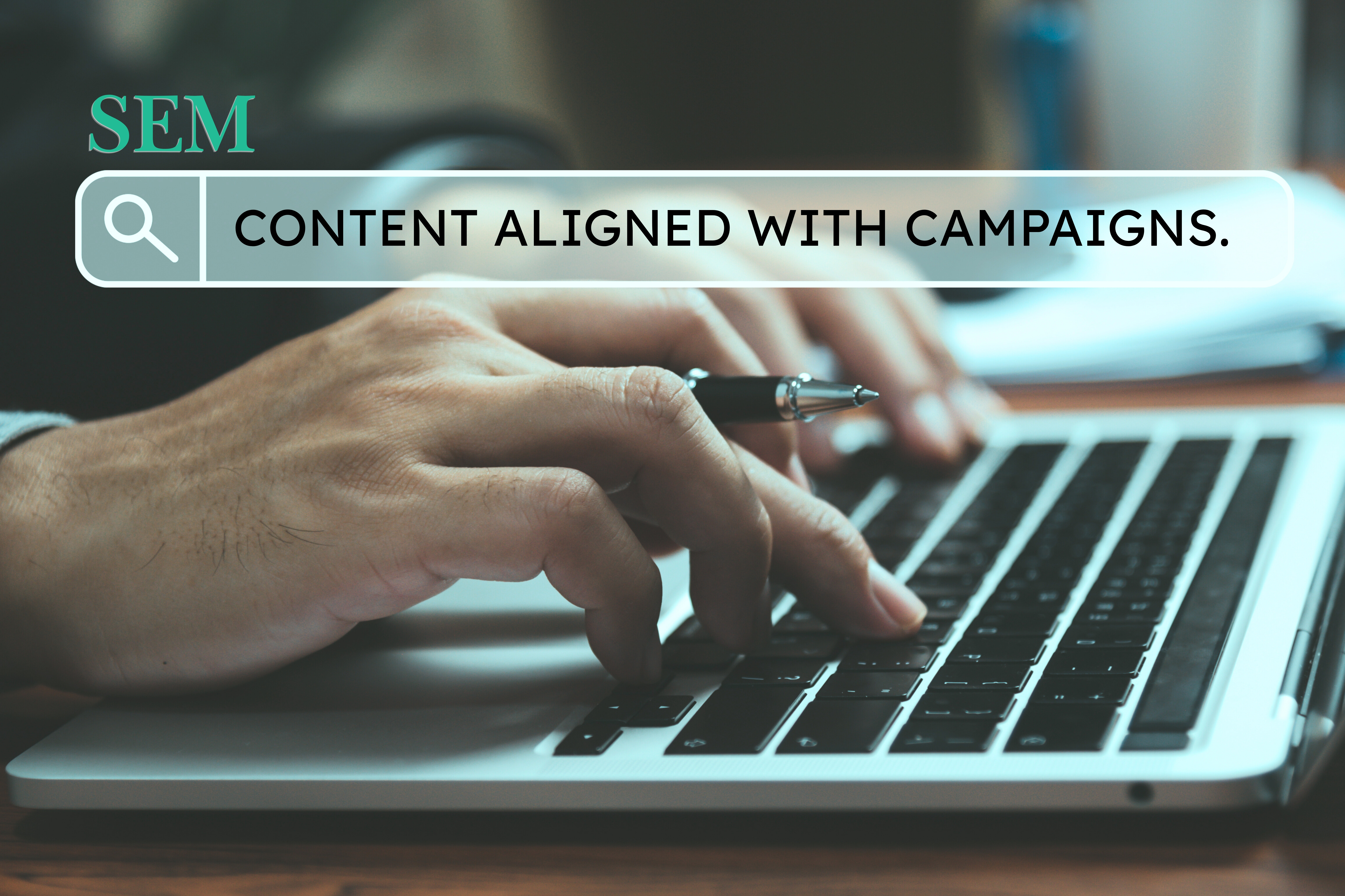 Hands typing on laptop with search bar graphic – SEM content aligned with campaigns
