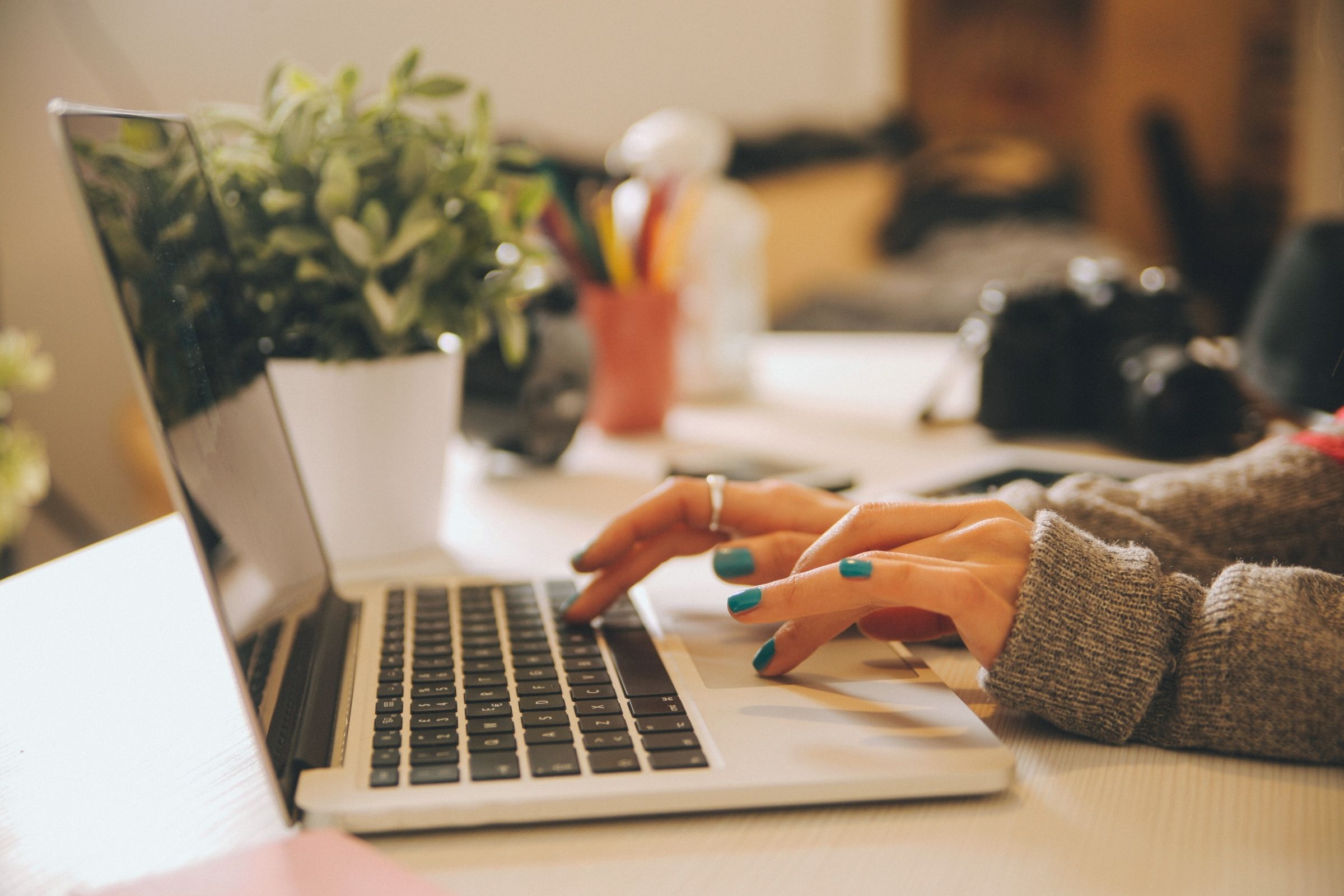 Minimal flat lay of laptop, notebook, and coffee cups symbolizing content creation and writing process